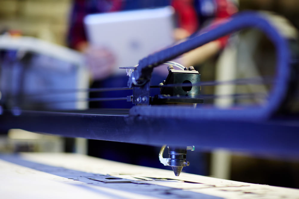 Welder finishing an aluminum sign can in the fabrication shop
