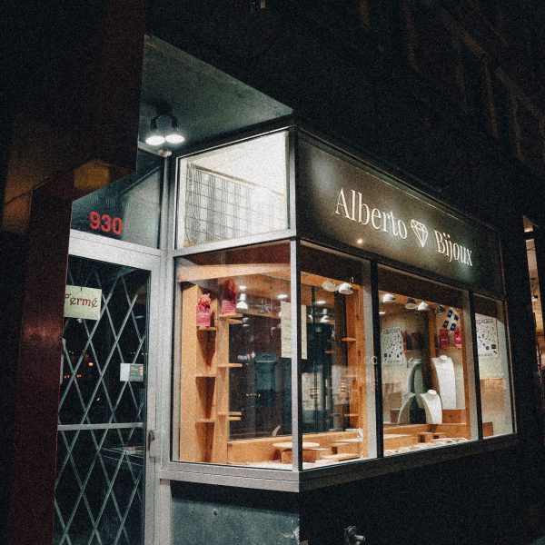 Retail facade sign above a storefront entry