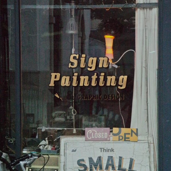 Hand-lettered window graphics on glass